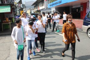 Grade 7 students with their adviser Mrs. Ezra Nicomedez, going to the Puericultural Center