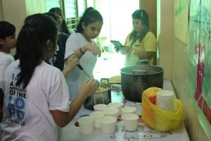 Grade 7 students preparing "Sopas" for the children.